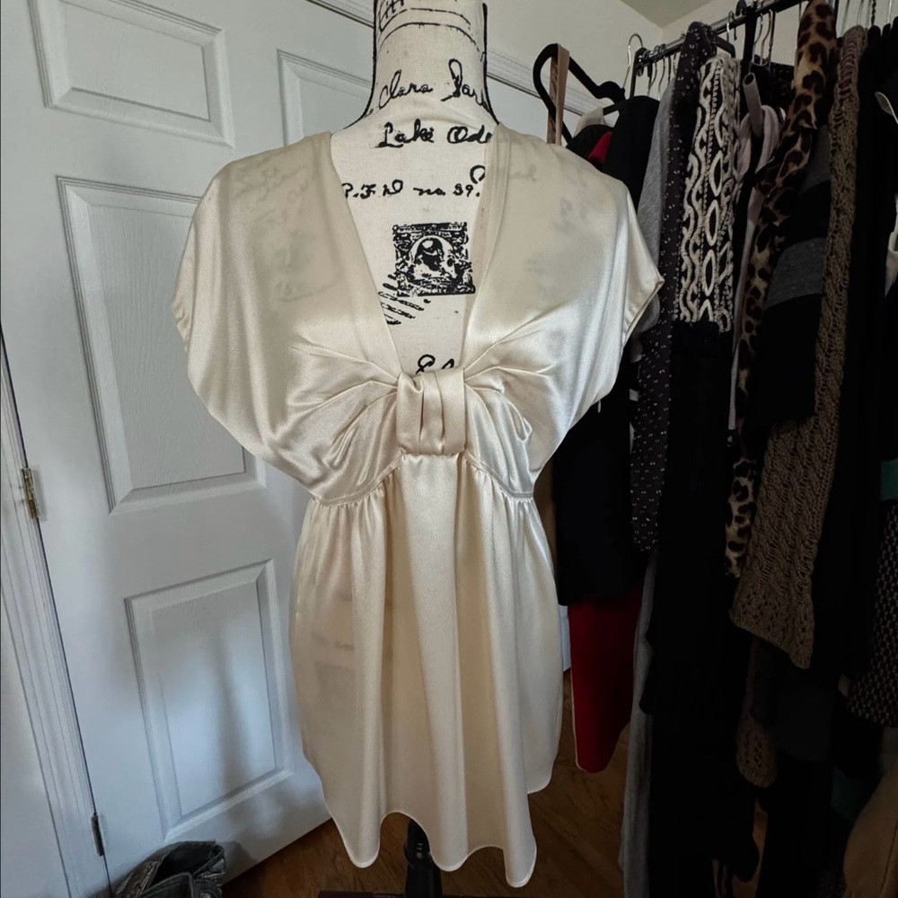 LaROK, launched in 2004 by L'Koral Inc Elegant Cream Satin Dress with Bow Detail